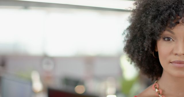 Confident Businesswoman with Curly Hair in Modern Office - Download Free Stock Images Pikwizard.com