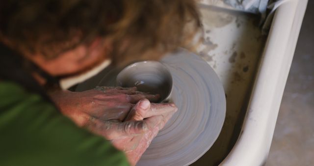 Close up view of male potter creating pottery on on potters wheel at pottery studio - Download Free Stock Photos Pikwizard.com