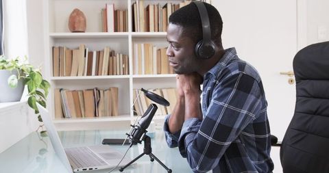 Podcast host recording episode at home studio with professional equipment