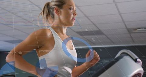 Woman exercising on treadmill with fitness tracking data displayed