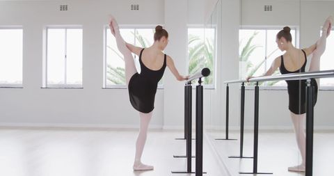 Young Ballerina Stretching at Barre in Bright Dance Studio - Download Free Stock Images Pikwizard.com