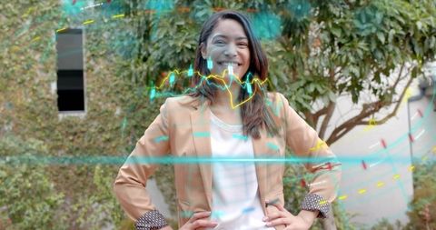 Confident businesswoman in tan blazer smiling with holographic data overlays in courtyard