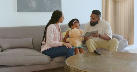Family Enjoyment with Technology and Toys in Cozy Living Space