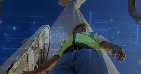 Engineering Technician Inspects Wind Turbine with Data Interface