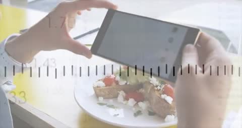 Person Capturing Avocado Toast with Smartphone in Modern Setting