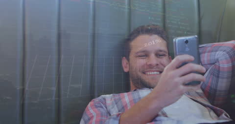 Man Relaxing and Engaging in Online Trading on Smartphone