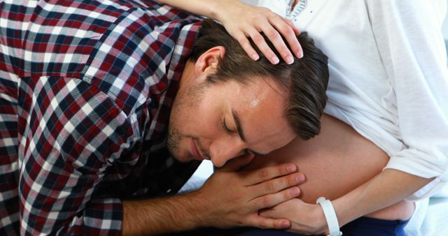 Expectant Father Listening to Pregnant Woman's Belly with Love and Care - Download Free Stock Images Pikwizard.com