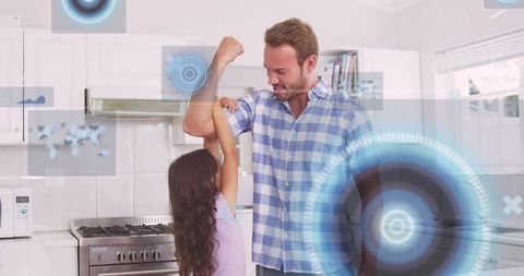 Father and daughter playing and flexing in modern kitchen for family bonding