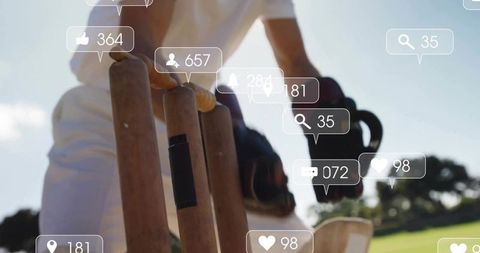 Reaching Cricketer Touching Stumps with Gloved Hand on Sunny Pitch with Social Overlay