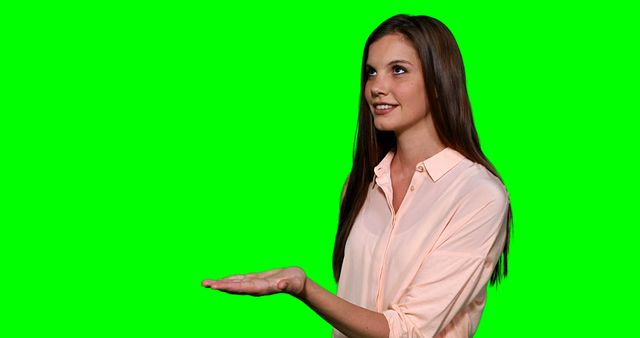 Woman pretending to touch digital screen against green screen - Download Free Stock Photos Pikwizard.com