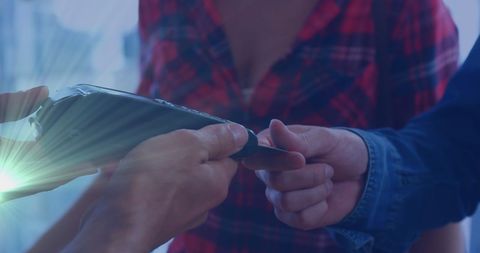 Couple paying with credit card in bright setting