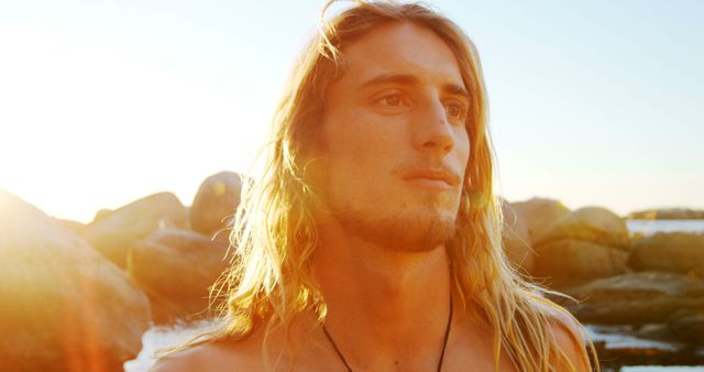 Young Man with Long Hair Looking to Horizon at Sunset - Download Free Stock Images Pikwizard.com