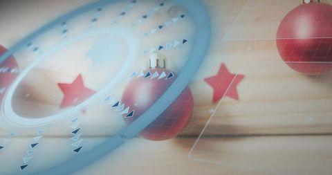 Showcasing glossy red baubles with translucent blue overlay on wooden plank with stars