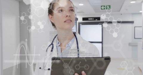 Nurse analyzing medical data on digital tablet in hospital