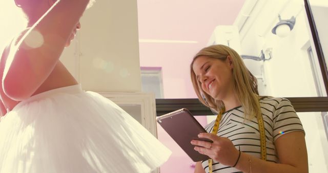 Seamstress Measuring Child for Ballet Costume Under Bright Sunlight - Download Free Stock Images Pikwizard.com