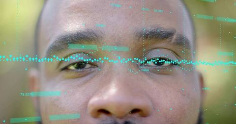 Mid-adult man gazing downward with turquoise hud overlay closeup portrait
