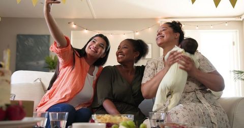 Happy Diverse Friends Celebrating Birthday with Baby in Living Room