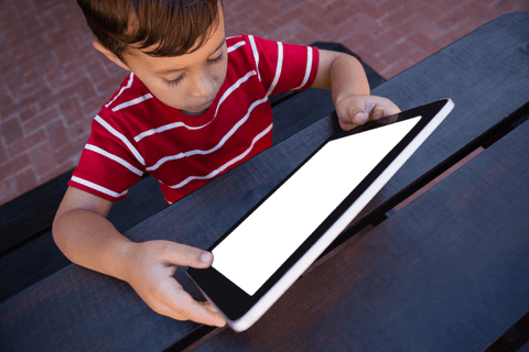 child using transparent screen tablet outdoors at table - Download Free Stock Videos Pikwizard.com