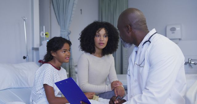 Doctor Consulting with Mother and Daughter in Hospital Room - Download Free Stock Images Pikwizard.com