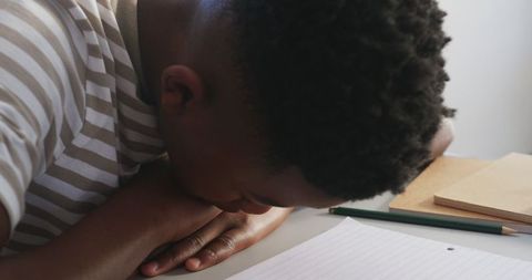 Young Student Concentrating on Study in Classroom with Striped-Shirt