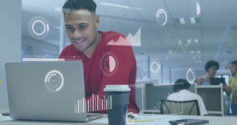 Smiling man working with data visualization in modern open-plan office