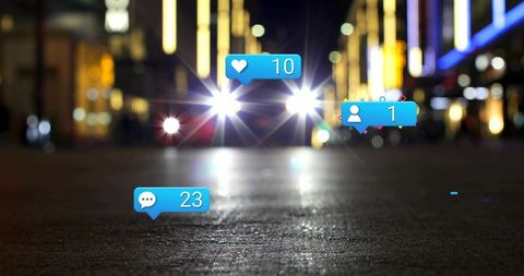 Car headlights creating lens flare on urban asphalt with social media notification overlays