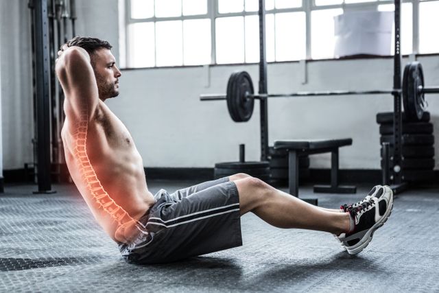 Digital composite of highlighted spine of exercising man at gym