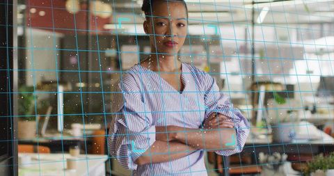 Confident professional in modern workspace with technology overlay