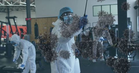 Healthcare workers disinfecting gym, covid-19 prevention efforts