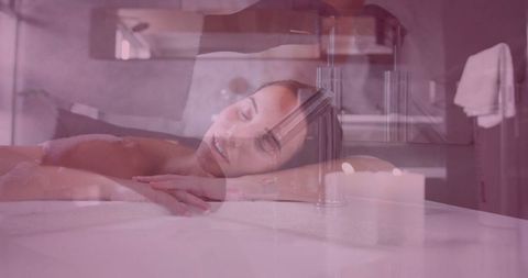 Relaxed woman enjoying spa massage with ambient candlelight