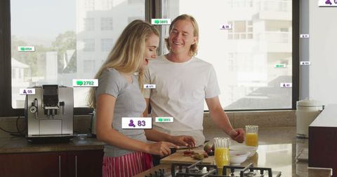 Couple Engaging with Social Media While Cooking in Bright Kitchen
