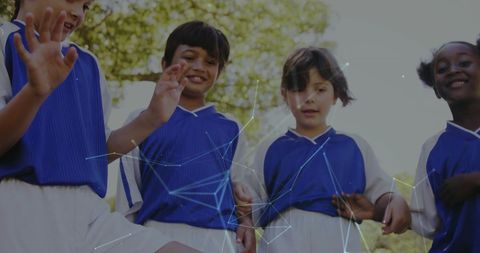 Children playing soccer with digital connectivity overlay