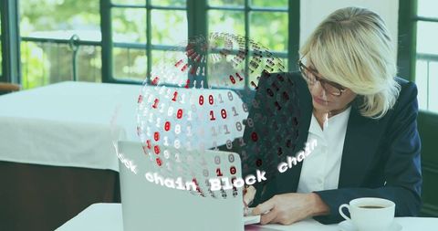 Businesswoman working with blockchain hologram globe on laptop and notebook in cafe