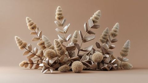 Dried grass plumes and metallic leaves still life