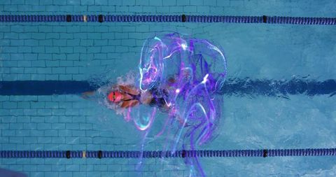 Swimmer in Action with Futuristic Light Effects