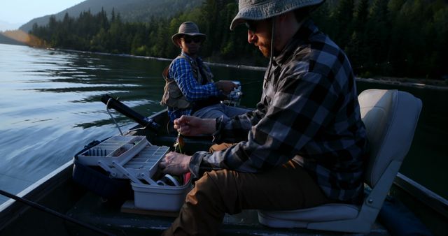 Two Men Fishing in a Boat on a Calm Lake During Sunset - Download Free Stock Images Pikwizard.com