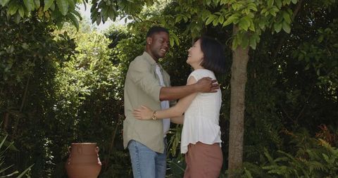Joyful Couple Dancing in Garden Embracing Special Moments