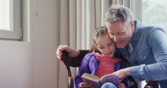 A middle-aged Caucasian man is reading a book to a young girl, with copy space. They share a moment of bonding and learning as they enjoy the story together.