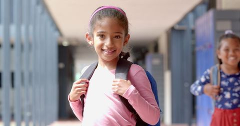 Happy Biracial Schoolgirls with Backpacks at School Corridor - Download Free Stock Images Pikwizard.com