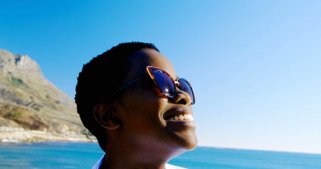 Joyful Woman Wearing Sunglasses Enjoying Coastal View - Download Free Stock Images Pikwizard.com