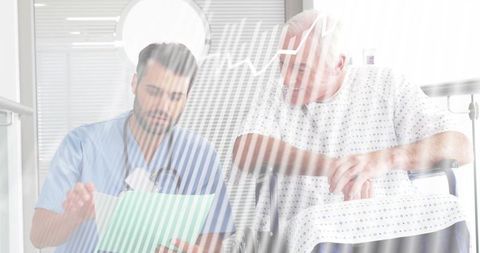 Clinician reviewing chart with senior patient in wheelchair during hospital consultation