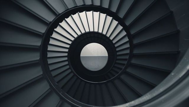 Futuristic spiral staircase with circular geometry and minimalist design