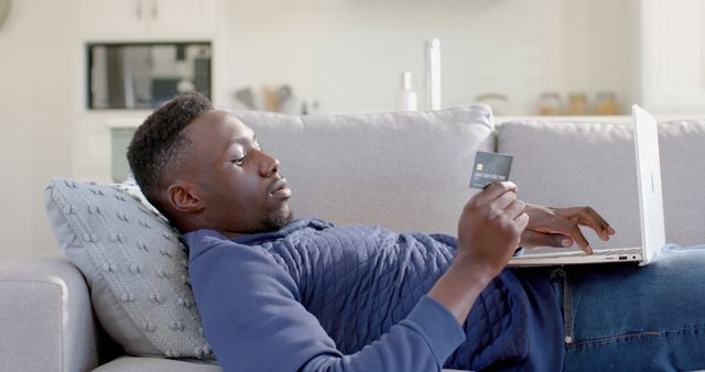 Man Relaxing on Couch with Laptop and Credit Card, Online Shopping - Download Free Stock Images Pikwizard.com