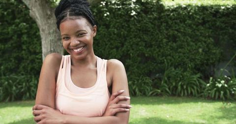 Smiling Young Woman Relaxing Outdoors in Summer Garden