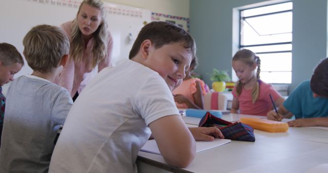 Primary School Students Engaged in Classroom Activities with Teacher Supervision - Download Free Stock Images Pikwizard.com