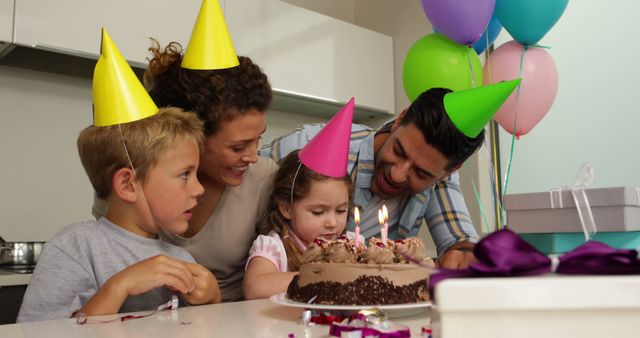 Family Celebrating Young Child's Birthday with Cake and Balloons - Download Free Stock Images Pikwizard.com