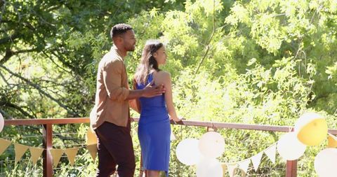 Romantic engagement celebration on sunlit terrace