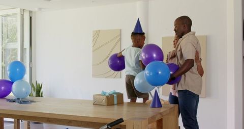 Family Celebrating Birthday with Decor and Balloons at Home