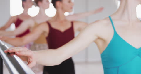 Caucasian Ballet Dancers Practicing at Barre
