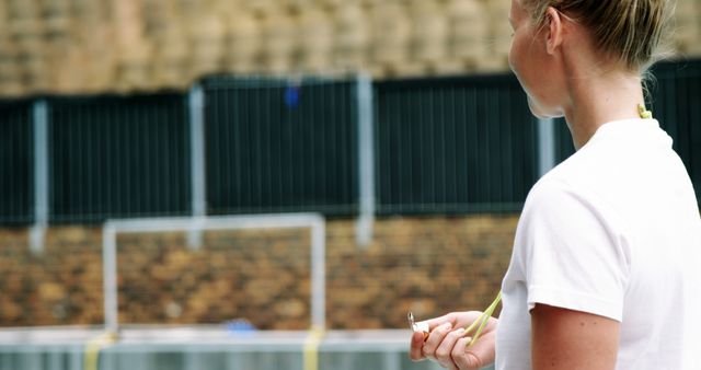 Focused Female Coach Holding Stopwatch at Outdoor Training Facility - Download Free Stock Images Pikwizard.com